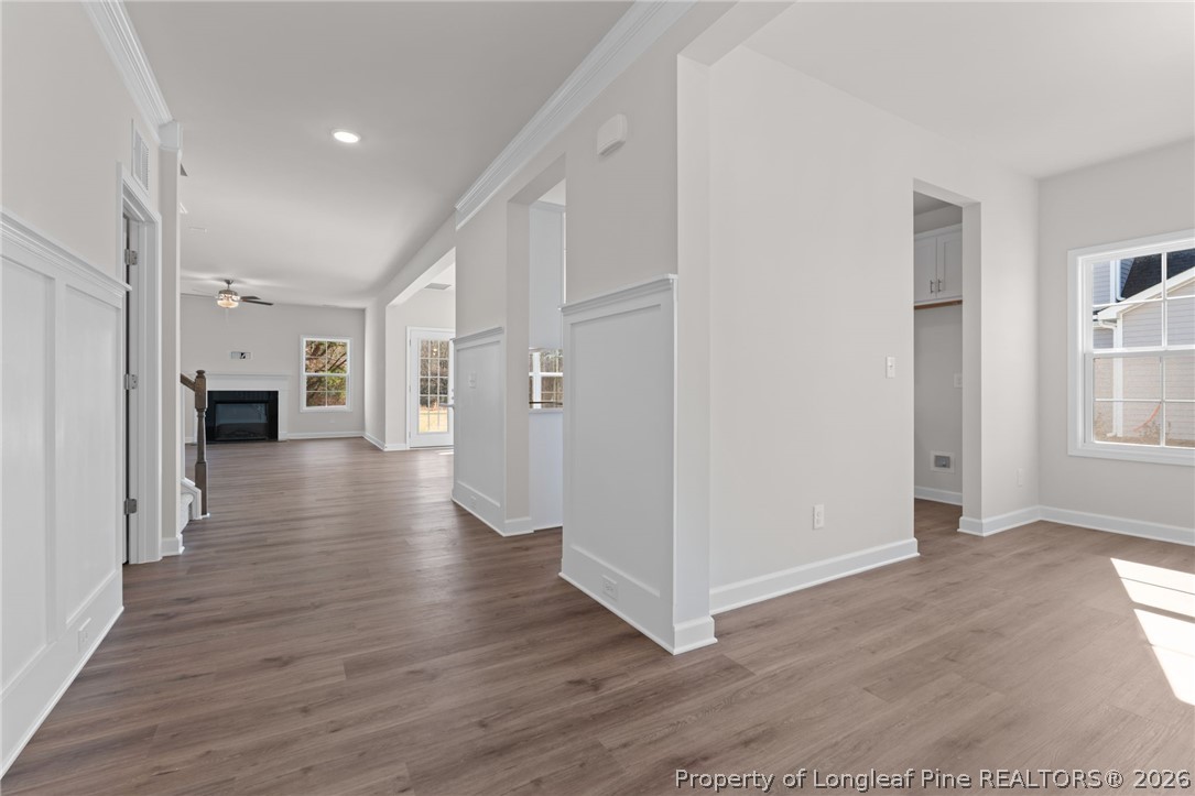 302 Elijah Way Vass, NC 28394 - Photo 8 of 44 a view of a hallway with wooden floor and a living room