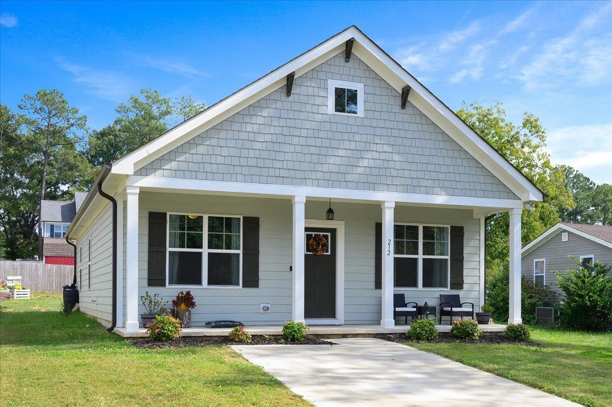 212 North Allen Road Wake Forest, NC 27587 - Photo 1 of 28 a front view of a house with a yard and potted plants