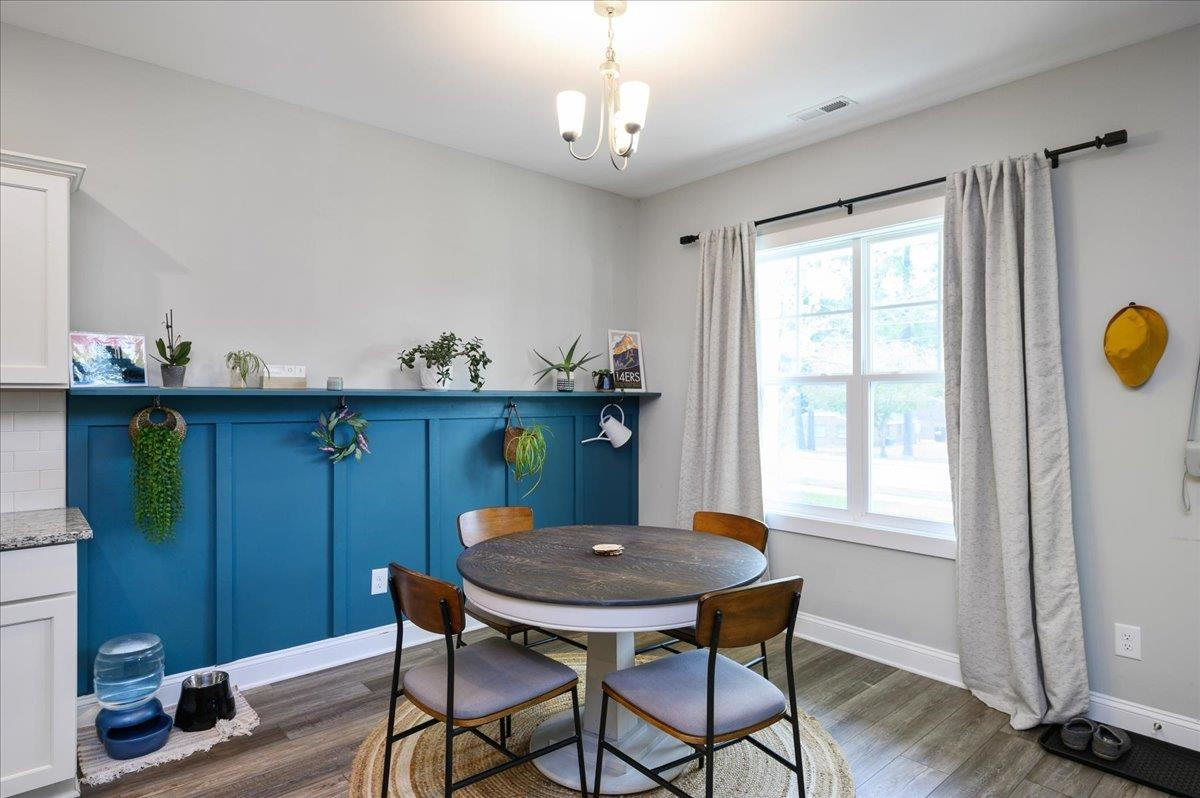 212 North Allen Road Wake Forest, NC 27587 - Photo 15 of 28 a view of a dining room with furniture and wooden floor