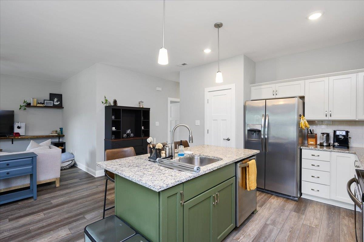212 North Allen Road Wake Forest, NC 27587 - Photo 17 of 28 a kitchen with a refrigerator a sink and a stove with wooden floor