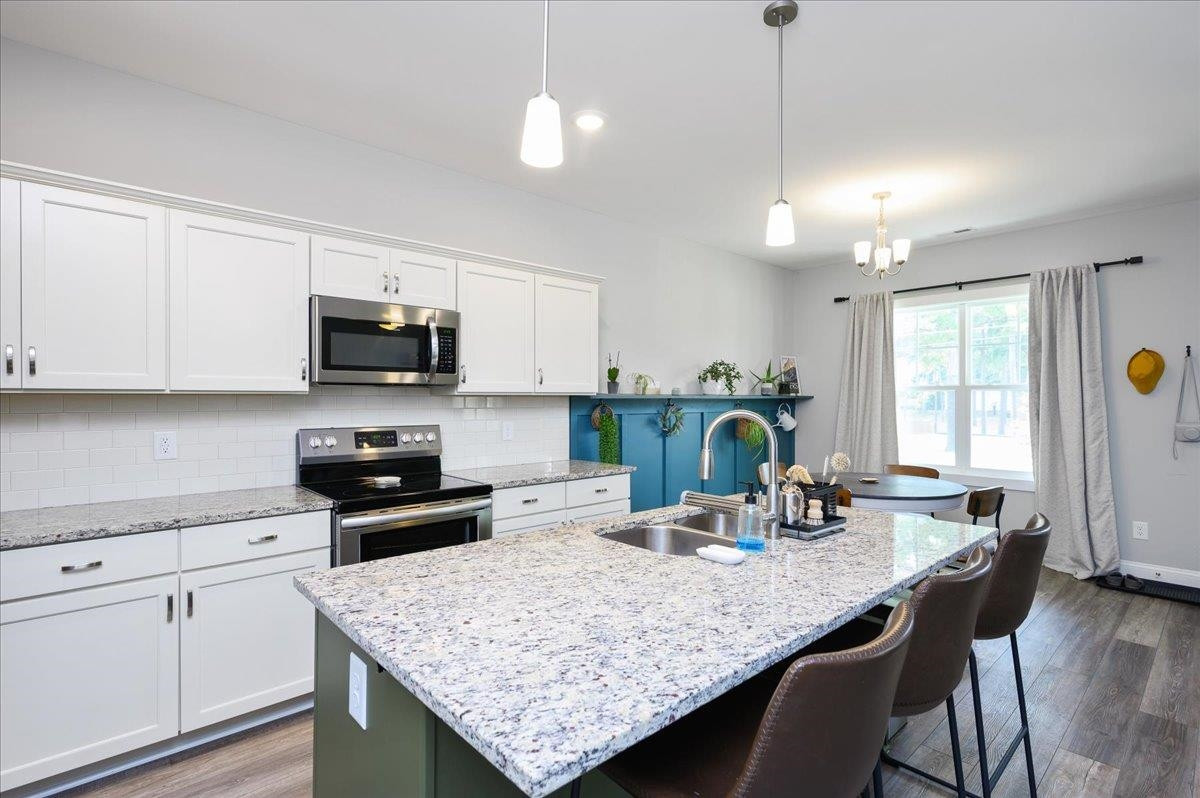 212 North Allen Road Wake Forest, NC 27587 - Photo 19 of 28 a kitchen with sink cabinets and wooden floor