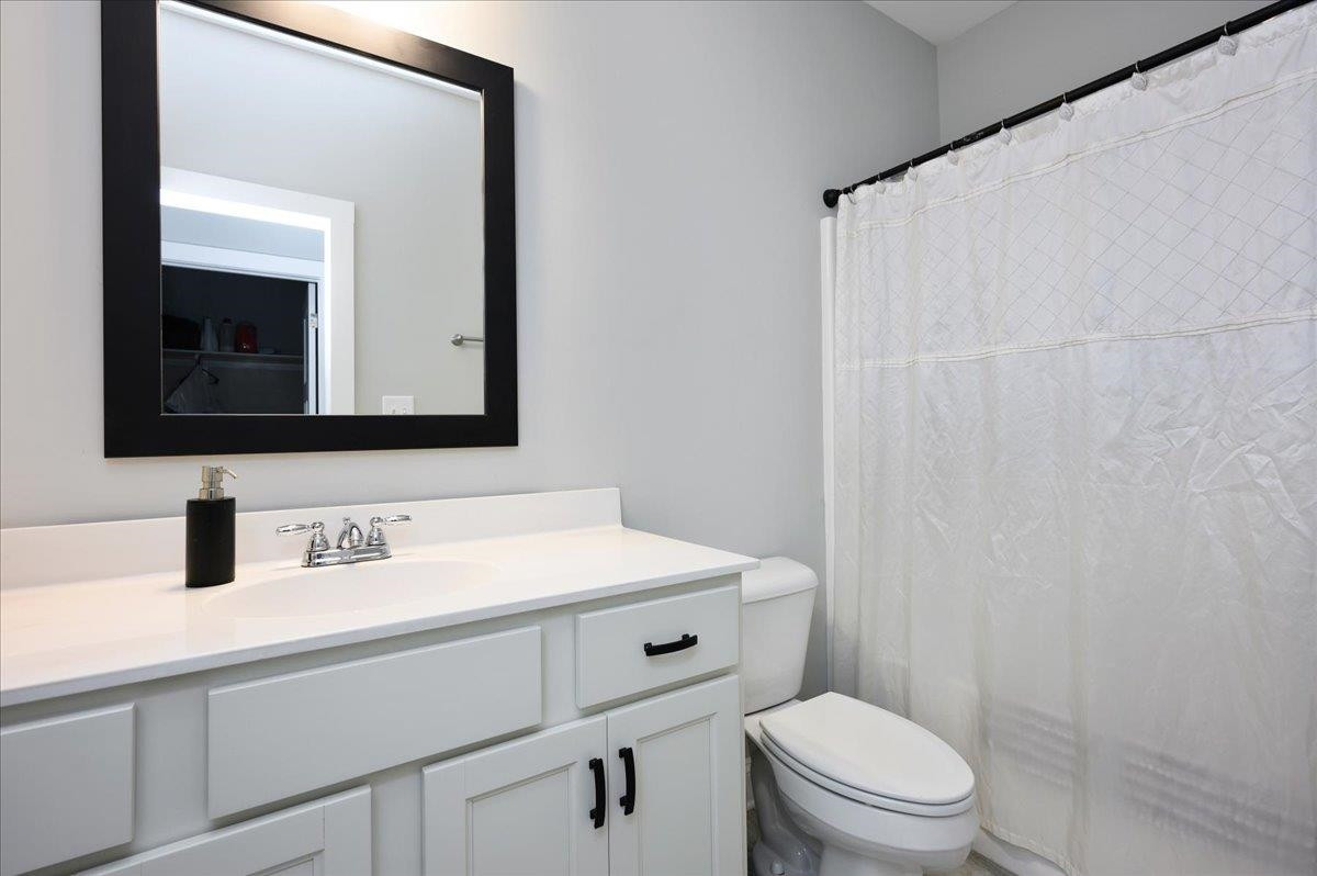 212 North Allen Road Wake Forest, NC 27587 - Photo 22 of 28 a bathroom with a toilet a sink and mirror