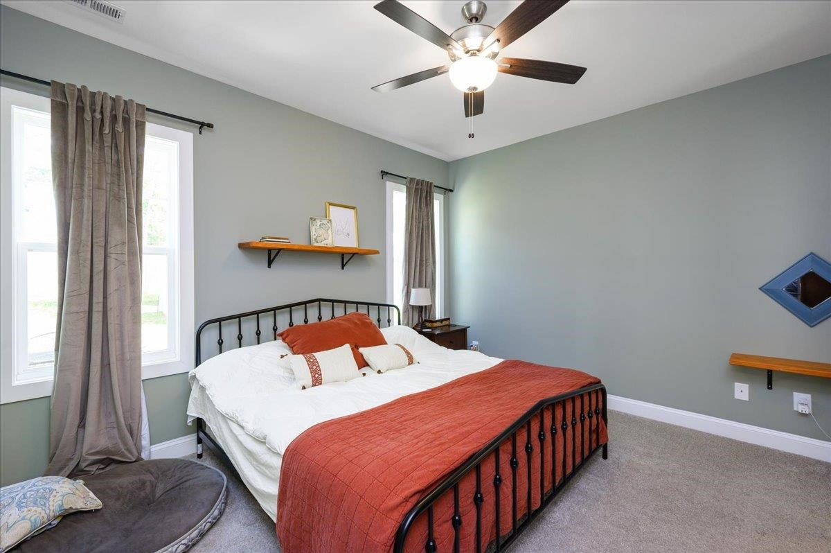 212 North Allen Road Wake Forest, NC 27587 - Photo 23 of 28 a bedroom with a bed and a chandelier