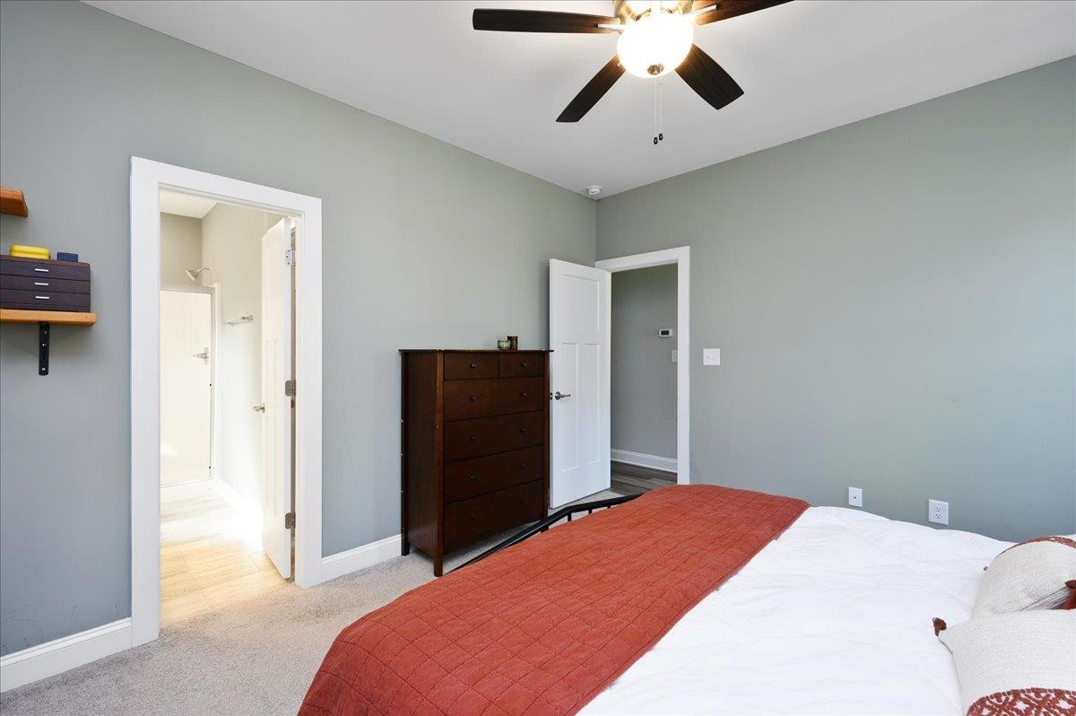 212 North Allen Road Wake Forest, NC 27587 - Photo 24 of 28 a bed room with a bed and a chandelier