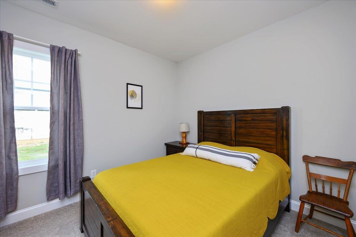 212 North Allen Road Wake Forest, NC 27587 - Photo 27 of 28 a bed sitting in a bedroom next to a window