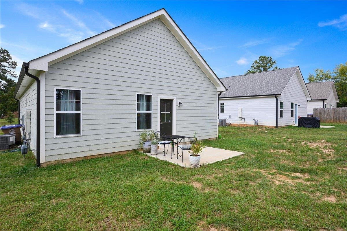 212 North Allen Road Wake Forest, NC 27587 - Photo 6 of 28 a view of a backyard with table and chairs and wooden fence