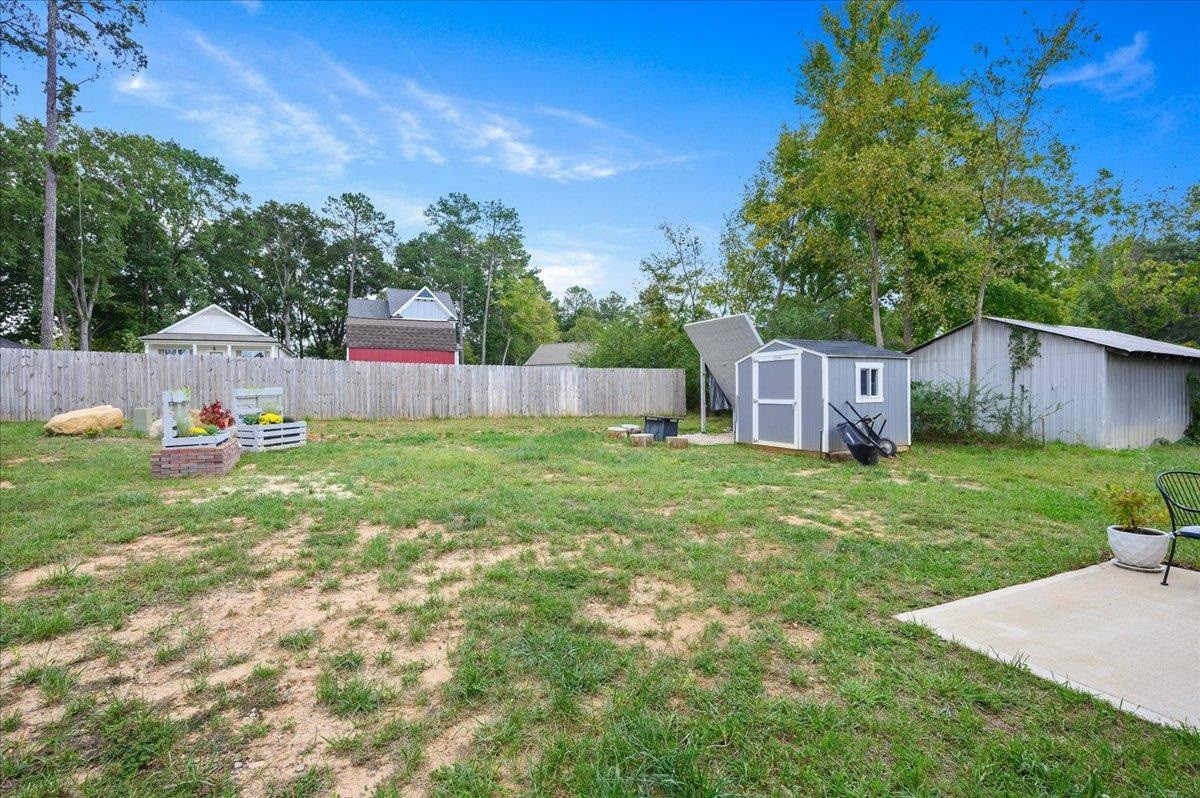 212 North Allen Road Wake Forest, NC 27587 - Photo 8 of 28 a backyard of a house with table and chairs plants and large tree