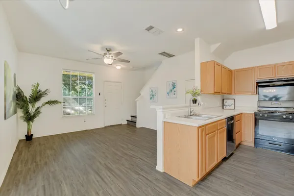 a front view of a house with a yard and trees