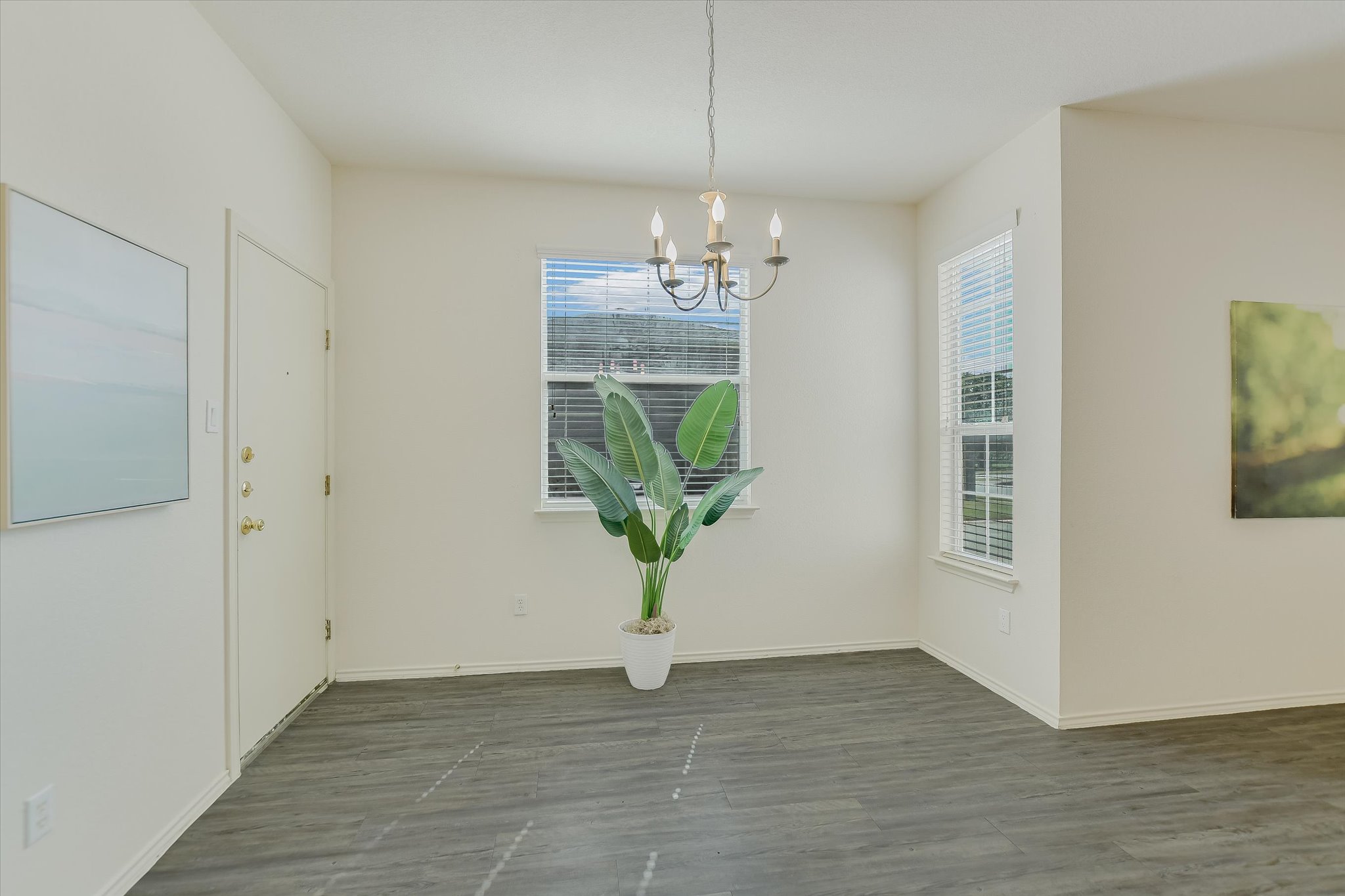 809 Sebastian Bend, Unit B Pflugerville, TX 78660 - Photo 12 of 34 a view of an empty room with wooden floor and a window