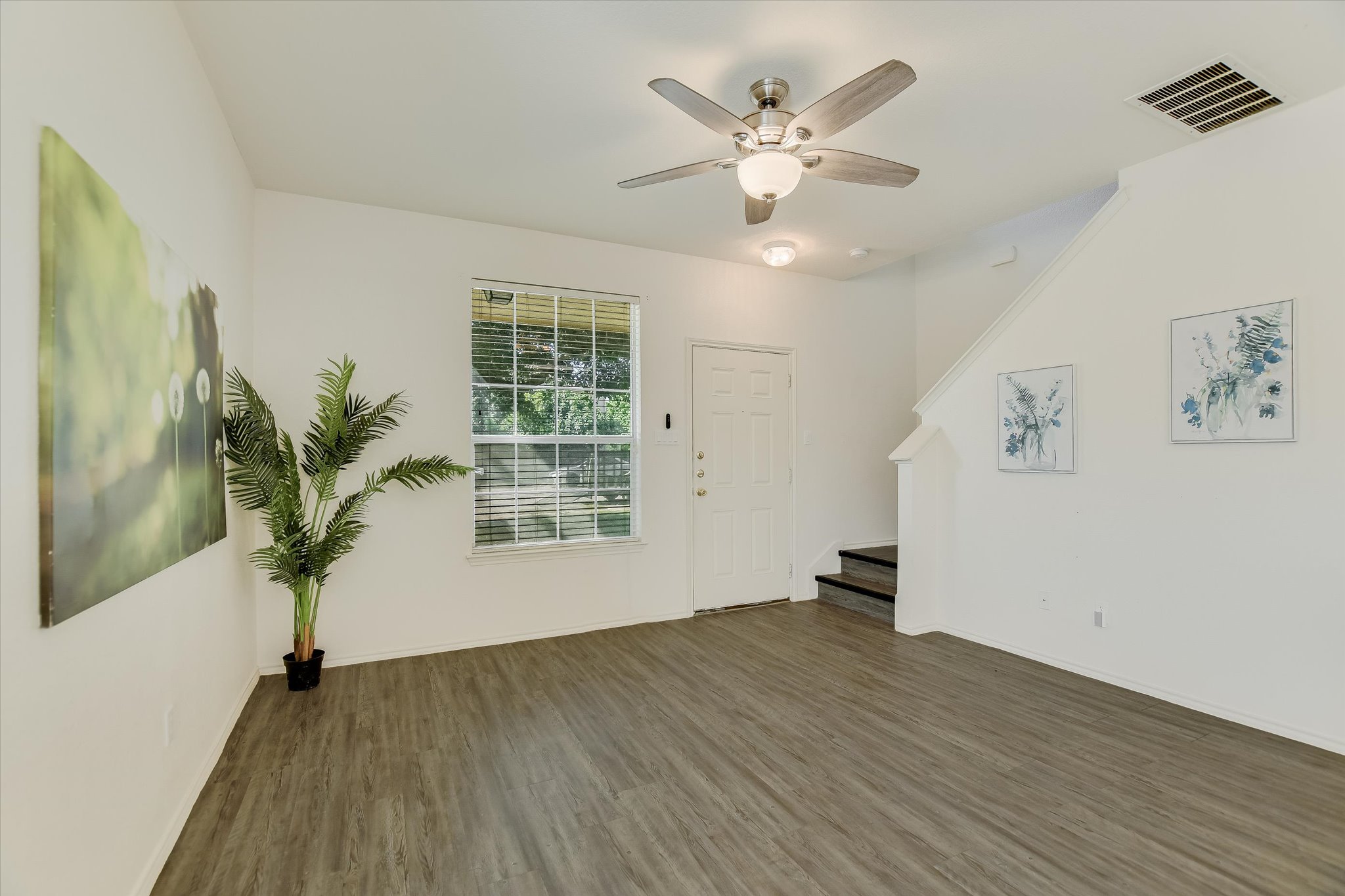 809 Sebastian Bend, Unit B Pflugerville, TX 78660 - Photo 13 of 34 wooden floor in an empty room with a window