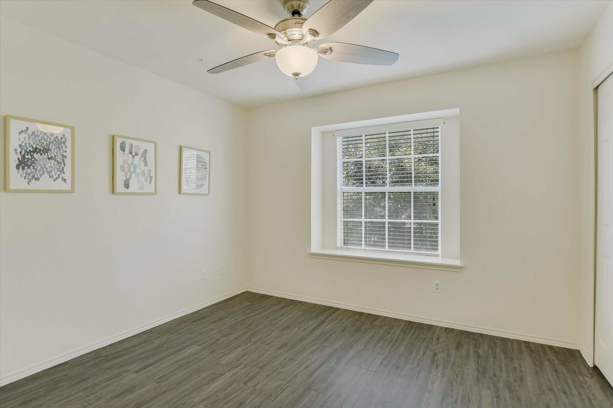 809 Sebastian Bend, Unit B Pflugerville, TX 78660 - Photo 18 of 34 a view of an empty room with wooden floor and a window