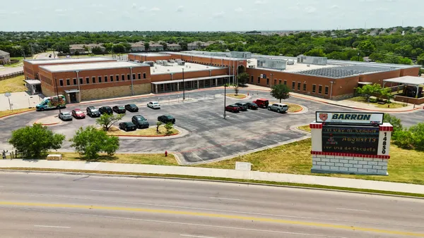 an aerial view of a house with swimming pool and outdoor seating