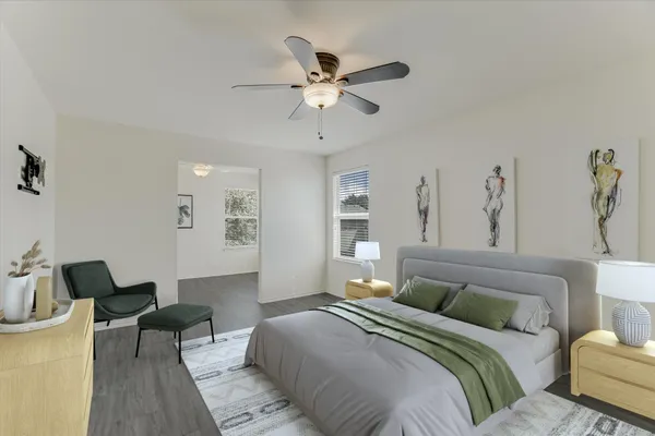 a living room with stainless steel appliances kitchen island hardwood floor and a sink