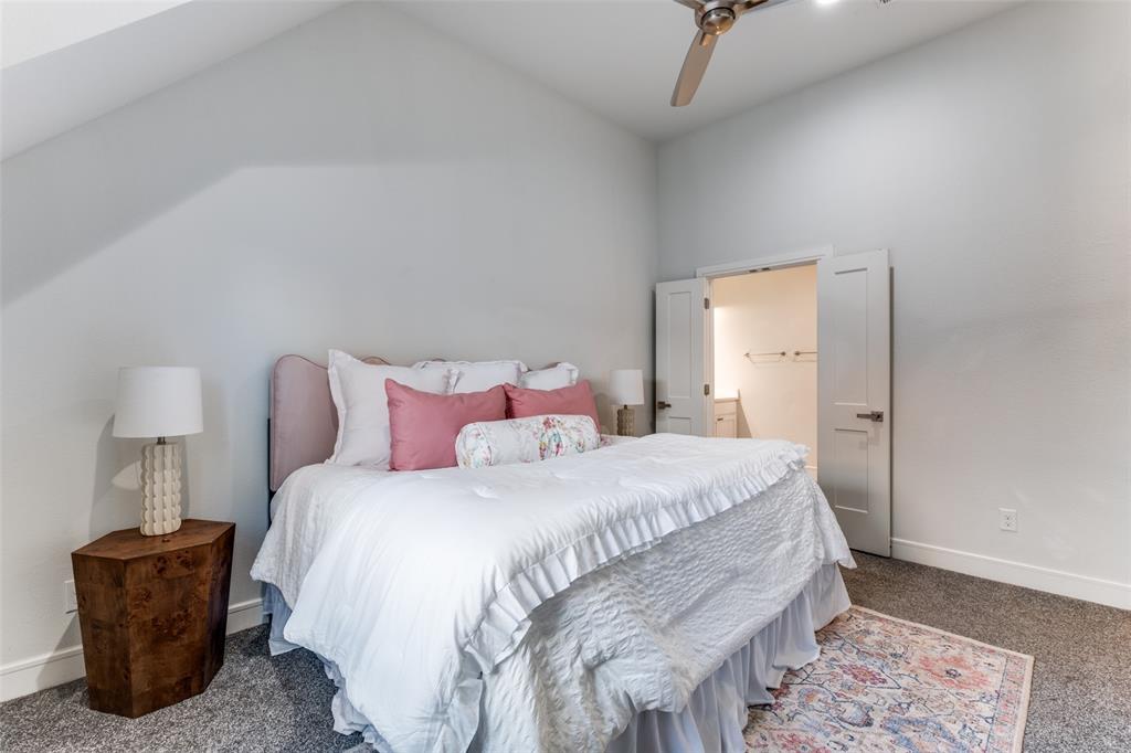 5073 Gaston Avenue, Unit 401 Dallas, TX 75214 - Photo 14 of 26 a bedroom with a bed and a lamp