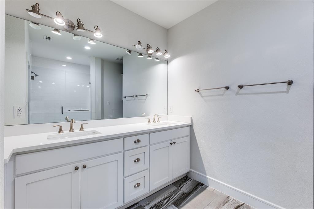 5073 Gaston Avenue, Unit 401 Dallas, TX 75214 - Photo 15 of 26 a bathroom with a double vanity sink and a mirror