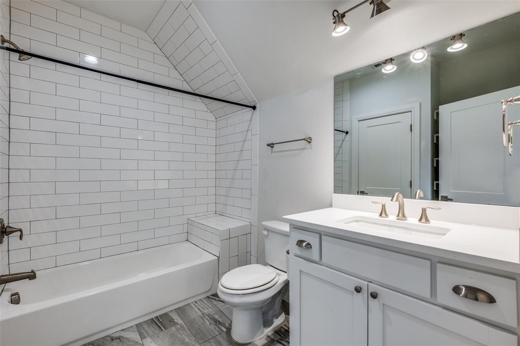 5073 Gaston Avenue, Unit 401 Dallas, TX 75214 - Photo 18 of 26 a bathroom with a sink mirror toilet and bathtub