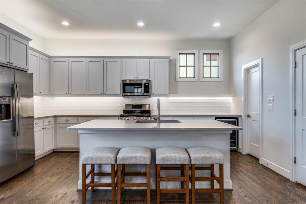 5073 Gaston Avenue, Unit 401 Dallas, TX 75214 - Photo 8 of 26 a kitchen with granite countertop white cabinets and stainless steel appliances