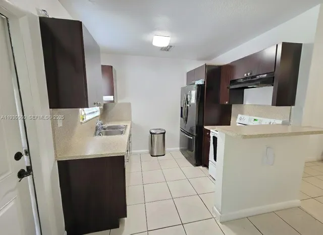 a kitchen with refrigerator and washer