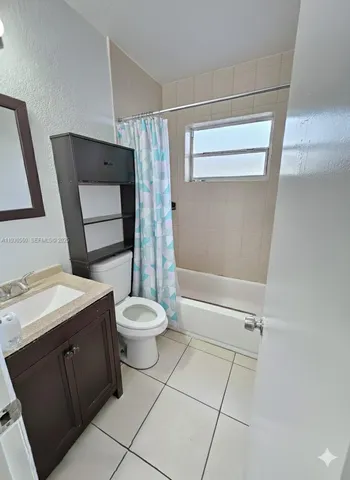 a bathroom with a toilet sink and shower