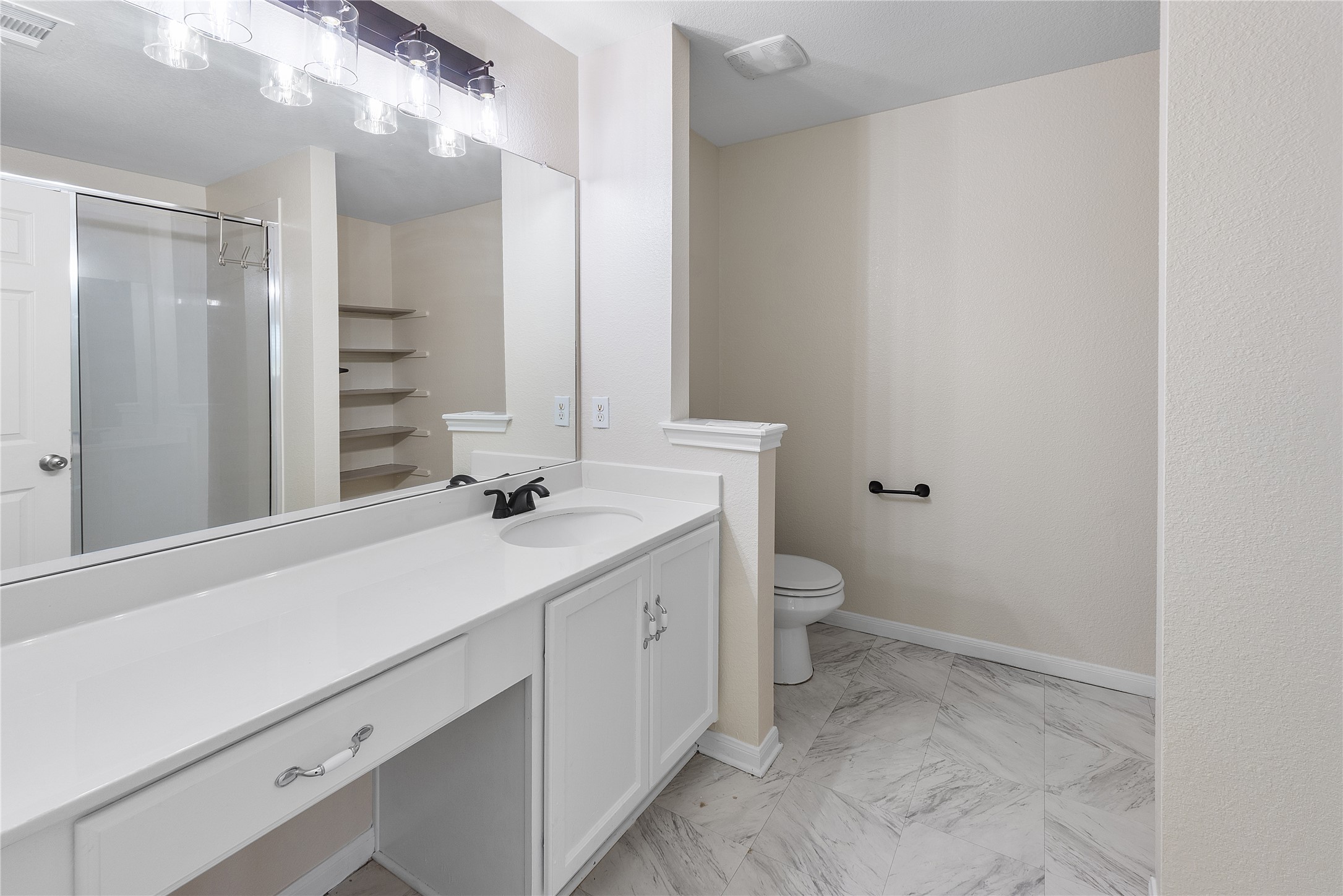 18436 Weatherby Lane Elgin, TX 78621 - Photo 11 of 23 Full bathroom with vanity, a stall shower, and light marble finish floors