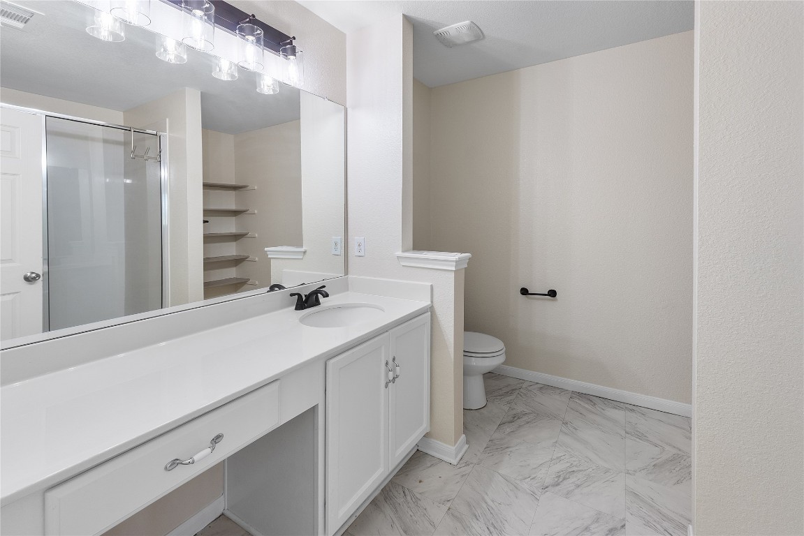 18436 Weatherby Lane Elgin, TX 78621 - Photo 11 of 23 a bathroom with a sink a toilet and shower