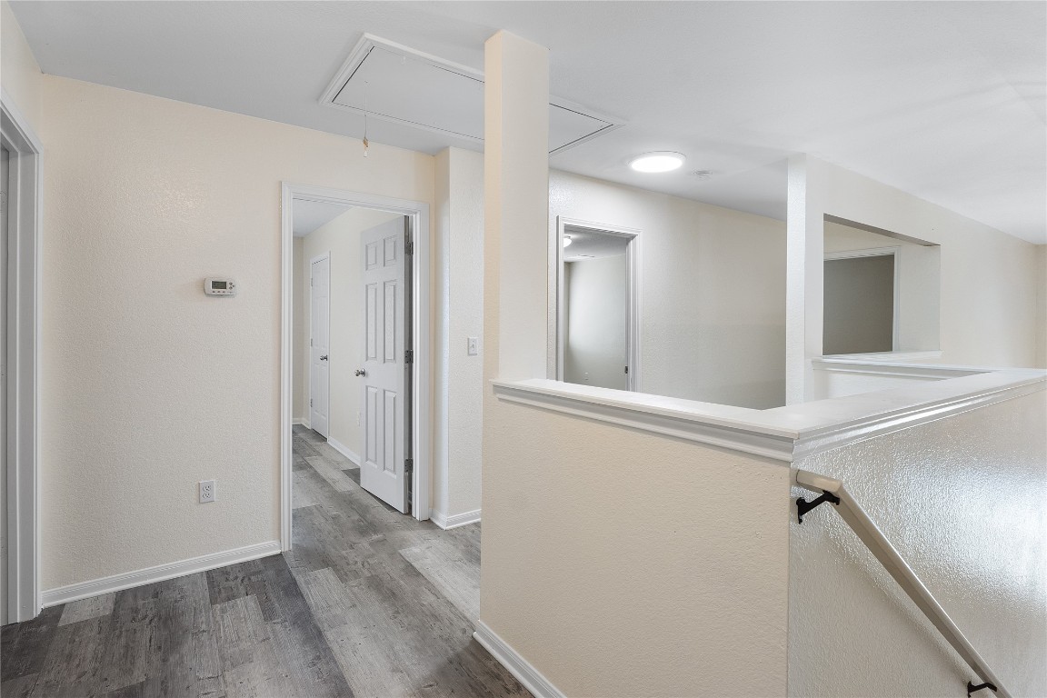 18436 Weatherby Lane Elgin, TX 78621 - Photo 13 of 23 a view of a hallway with wooden floor