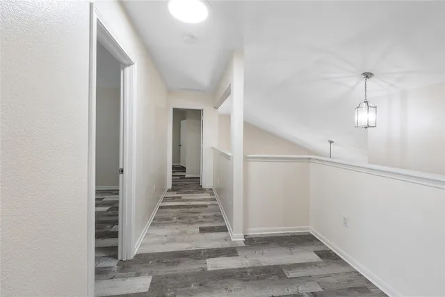 a view of a hallway view with wooden floor and staircase