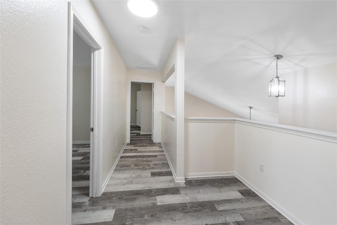 18436 Weatherby Lane Elgin, TX 78621 - Photo 16 of 23 an empty room with staircase and white walls