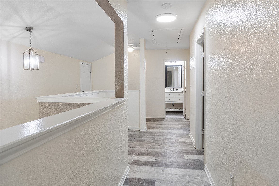 18436 Weatherby Lane Elgin, TX 78621 - Photo 17 of 23 a view of a hallway view with wooden floor and staircase
