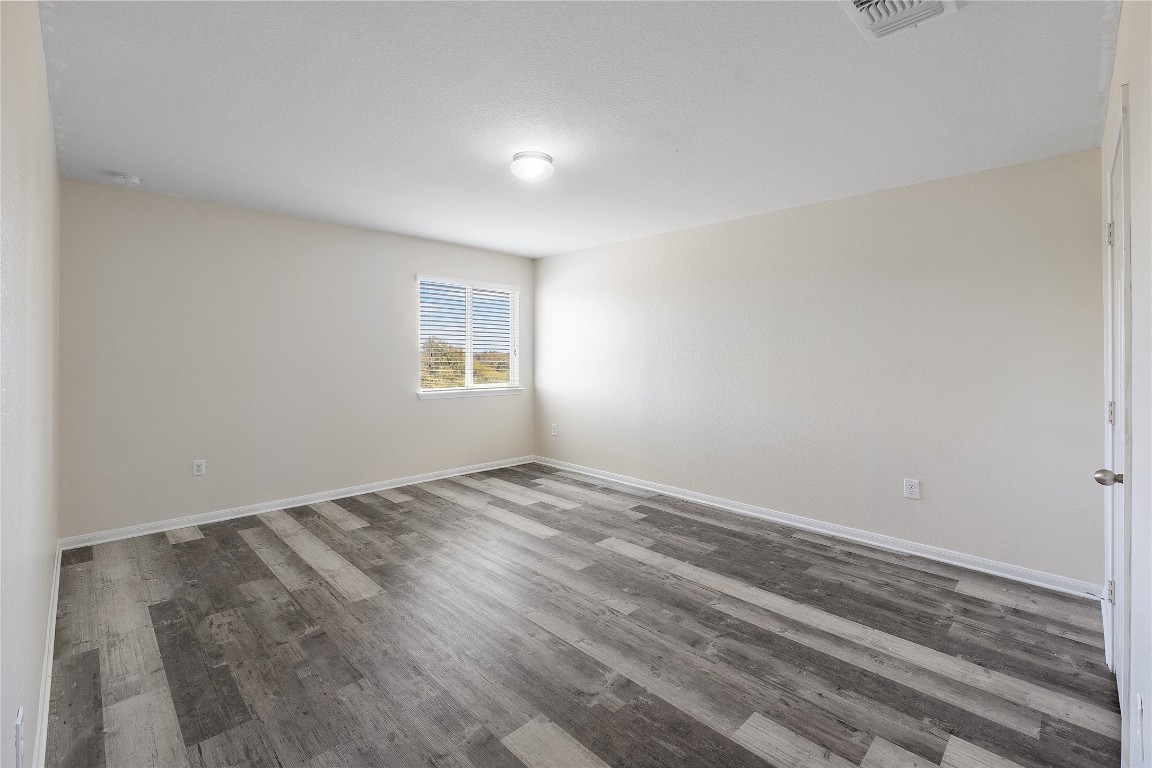 18436 Weatherby Lane Elgin, TX 78621 - Photo 18 of 23 a view of empty room with wooden floor and fan
