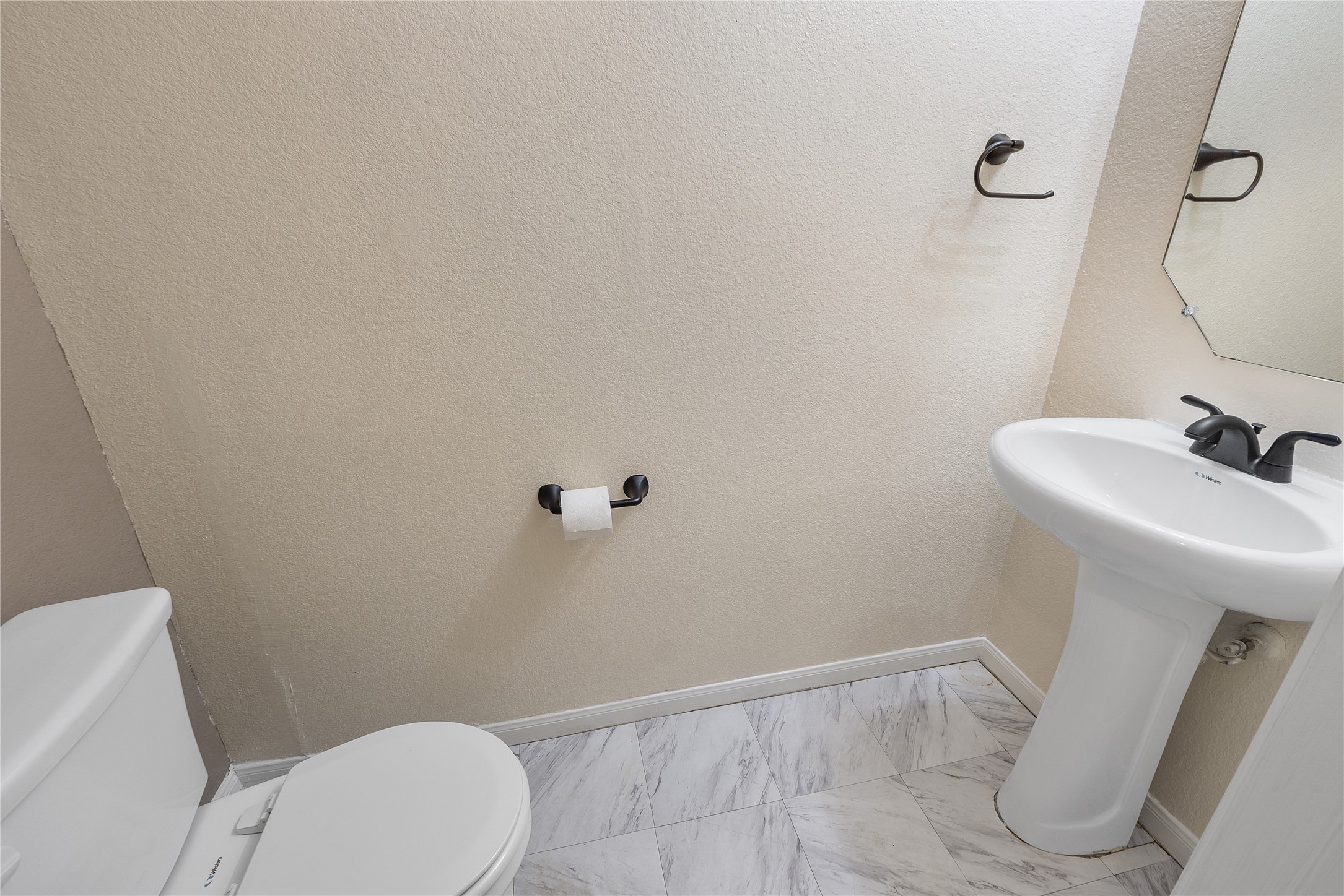 18436 Weatherby Lane Elgin, TX 78621 - Photo 21 of 23 Bathroom featuring a textured wall and light marble finish flooring