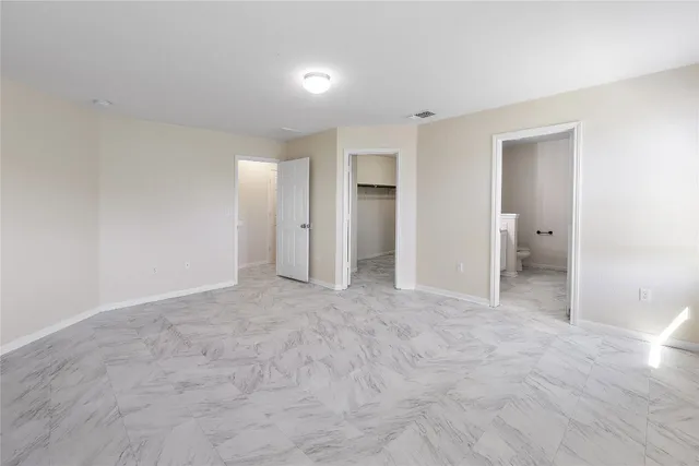 a view of an empty room and closet