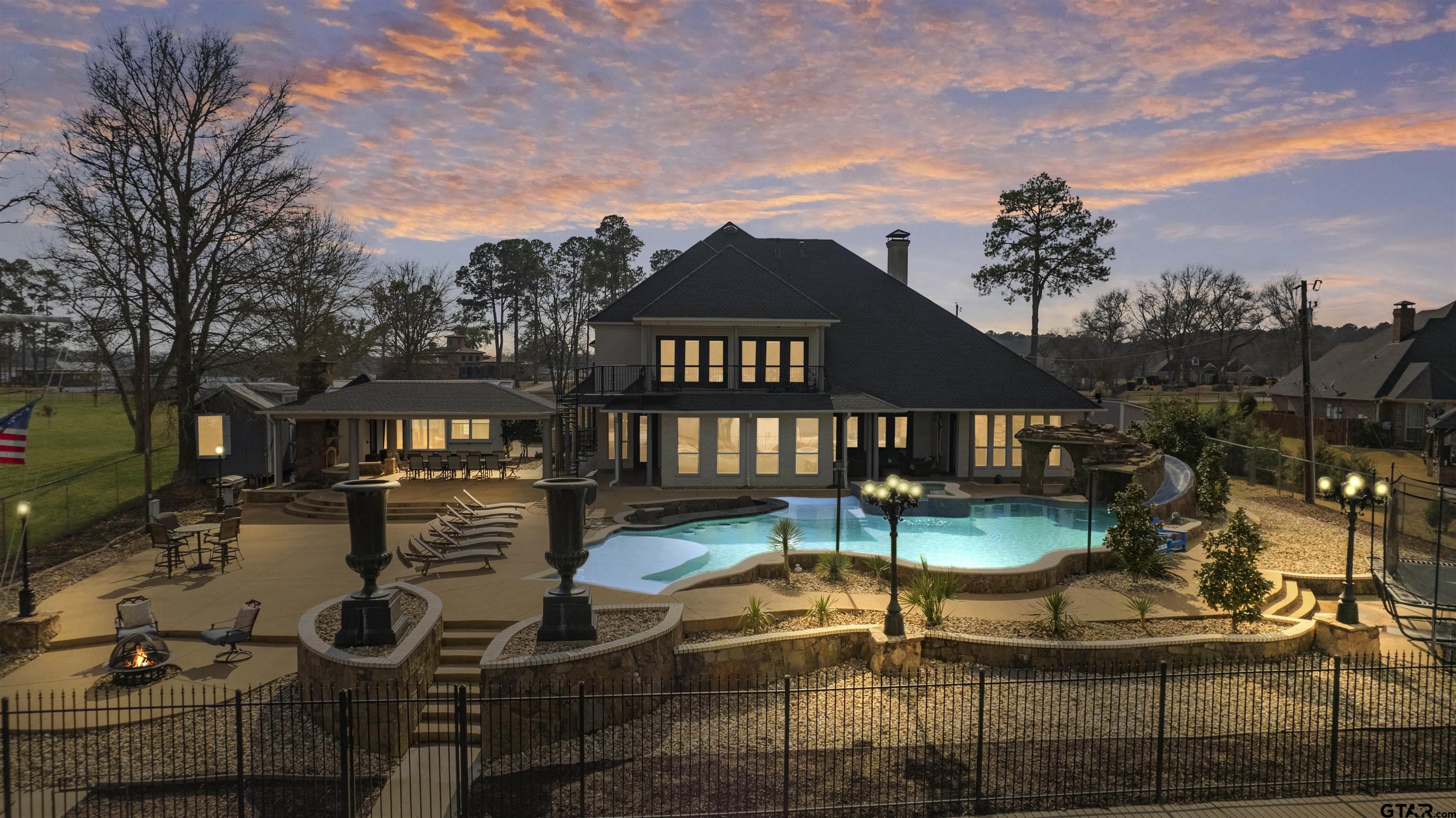a view of a house with backyard porch and sitting area