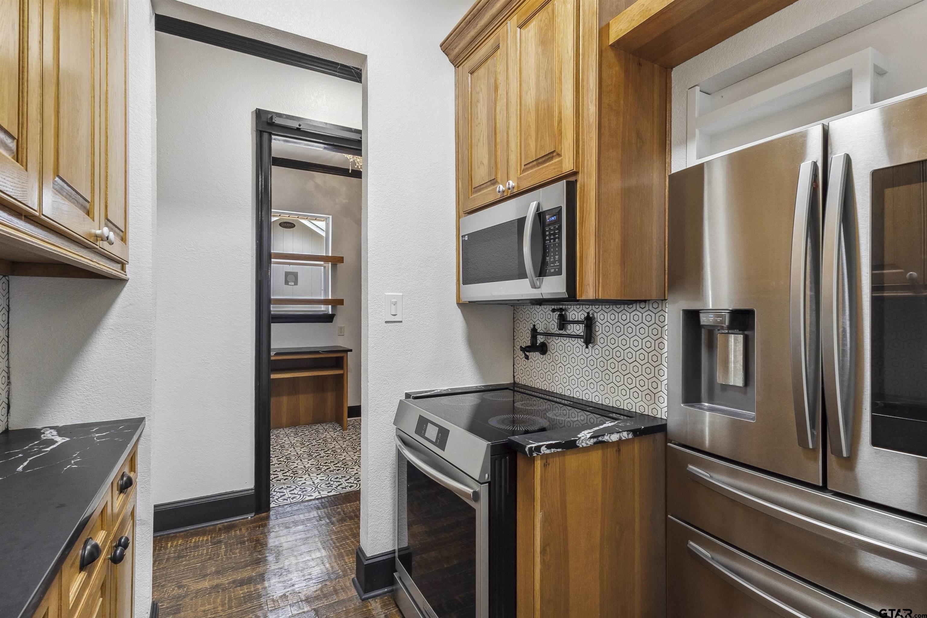 17729 Southpoint Road Whitehouse, TX 75791 - Photo 17 of 48 a kitchen with stainless steel appliances granite countertop a refrigerator stove and sink