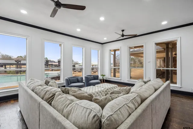 a living room with furniture and large windows