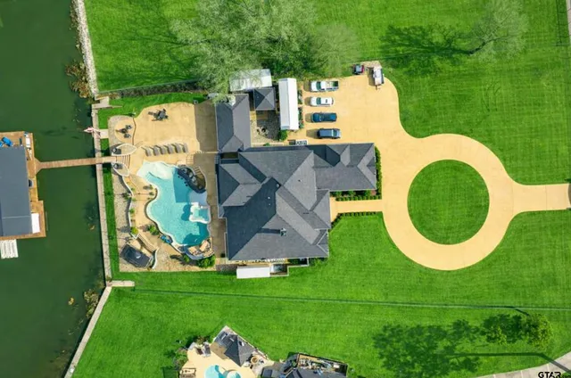 a view of a house with swimming pool and furniture