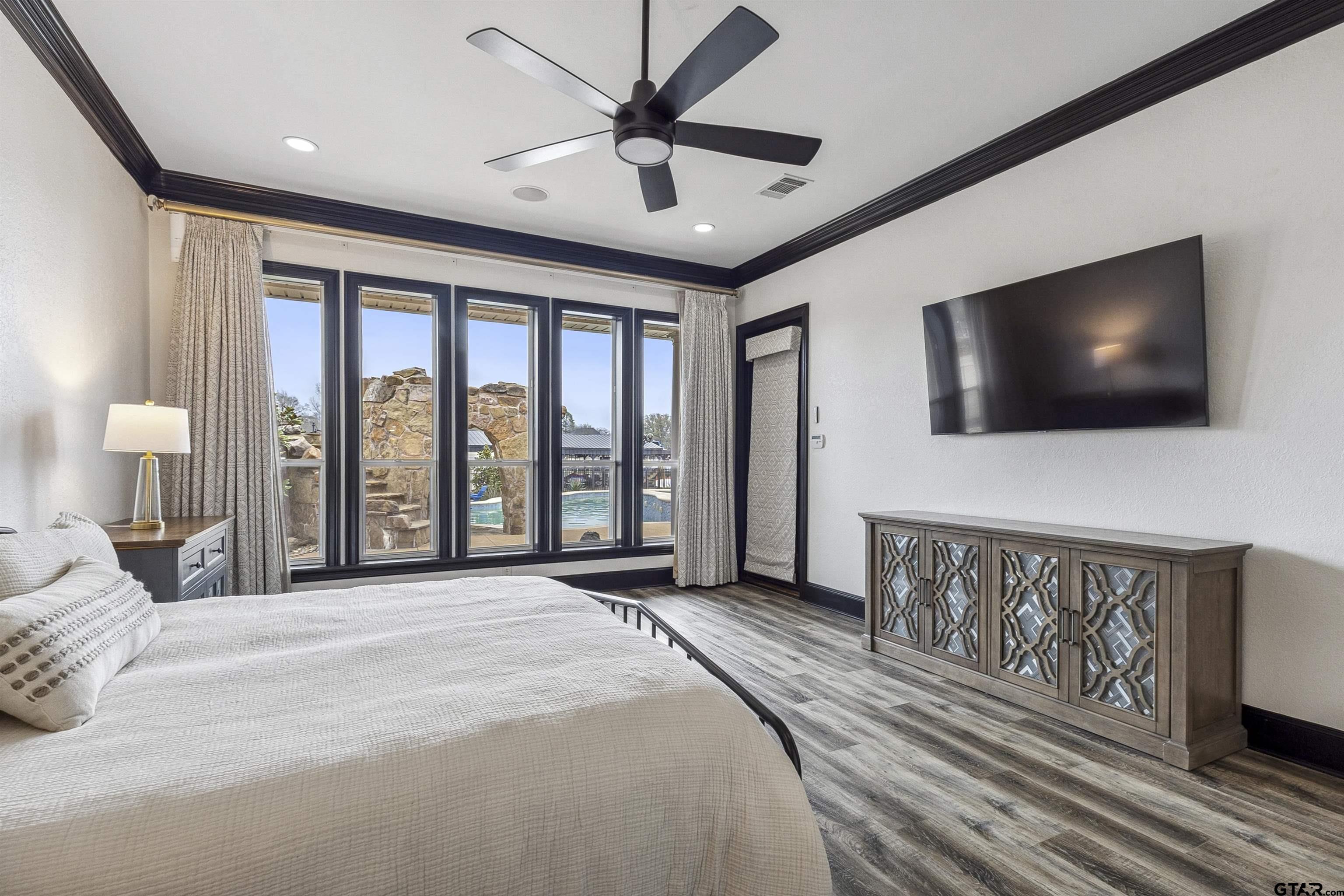 17729 Southpoint Road Whitehouse, TX 75791 - Photo 22 of 48 a spacious bedroom with a bed and a flat screen tv