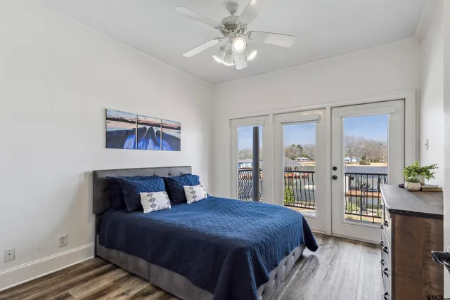 a bedroom with a large bed and a chandelier