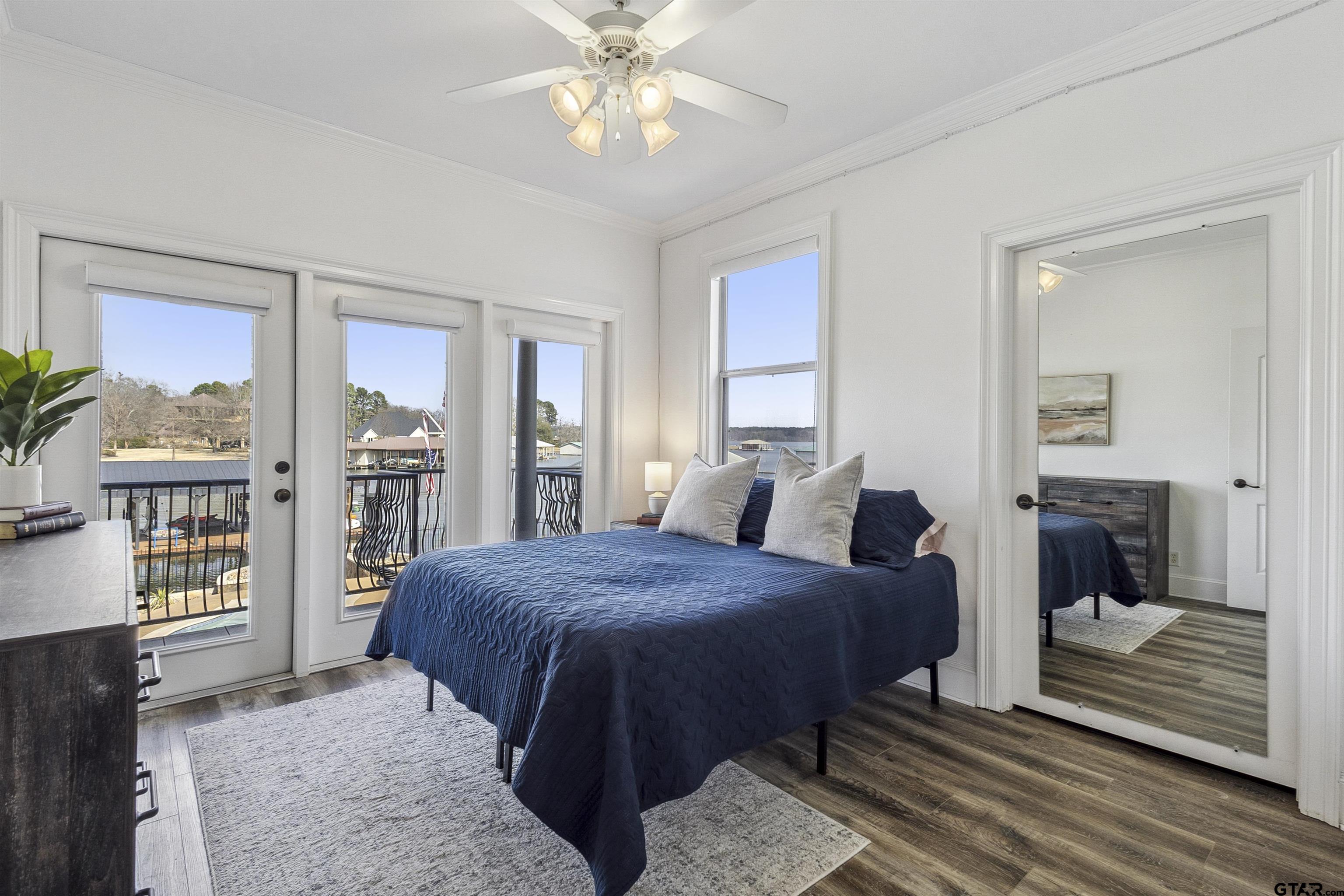 17729 Southpoint Road Whitehouse, TX 75791 - Photo 31 of 48 a bedroom with a large bed and a chandelier