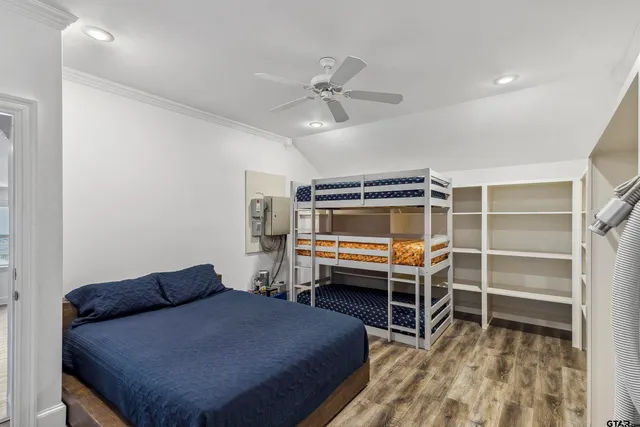 a bedroom with a bunk bed and a ceiling fan