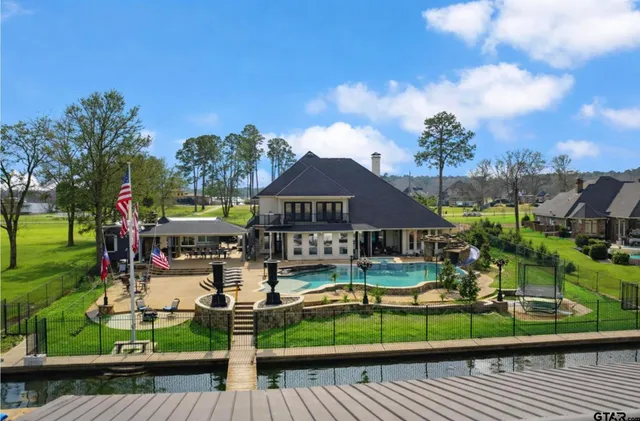 a living room with furniture and large windows