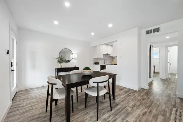 a view of a dining room with furniture and wooden floor