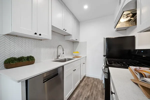 a kitchen with a sink and cabinets