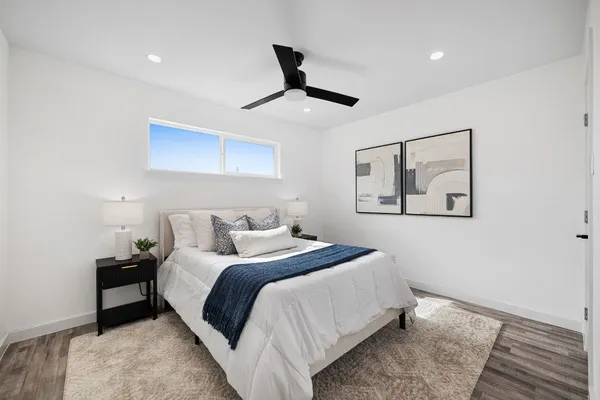 a bedroom with a bed and a painting on the wall