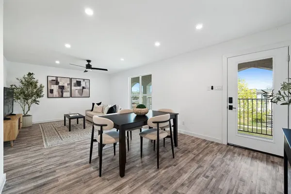 a view of a dining room with furniture and wooden floor