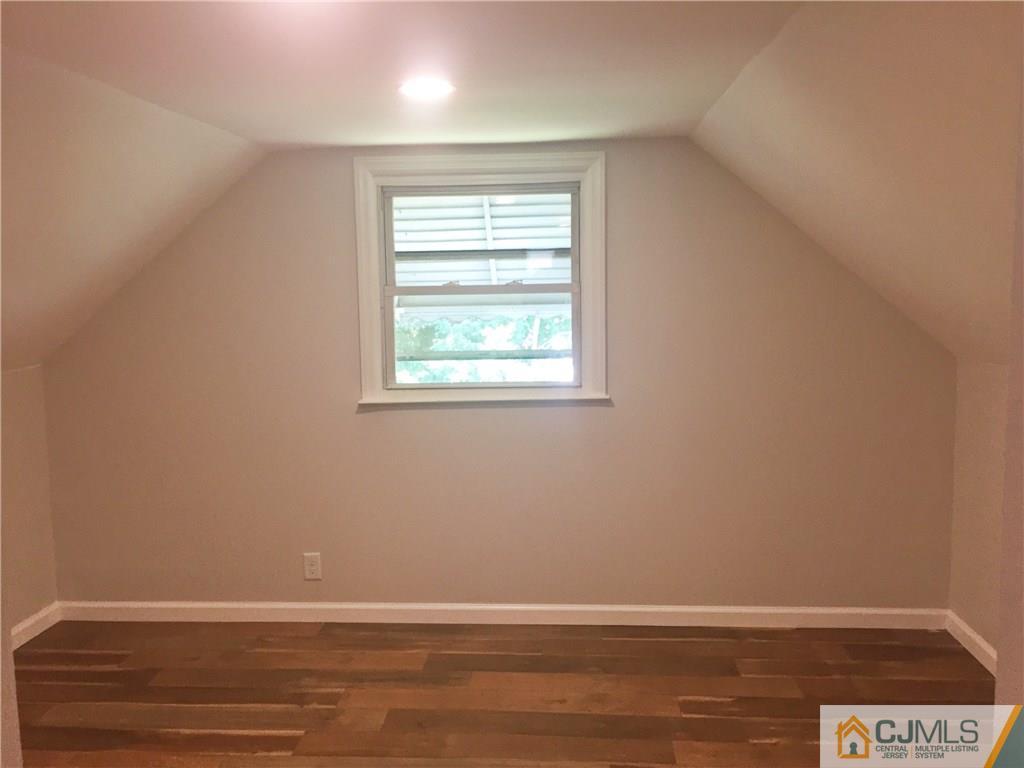 38 Sine Road Edison, NJ 08817 - Photo 11 of 15 an empty room with wooden floor and windows