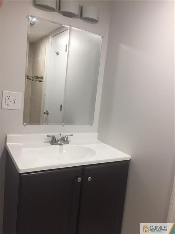 38 Sine Road Edison, NJ 08817 - Photo 13 of 15 a bathroom with a sink and a mirror
