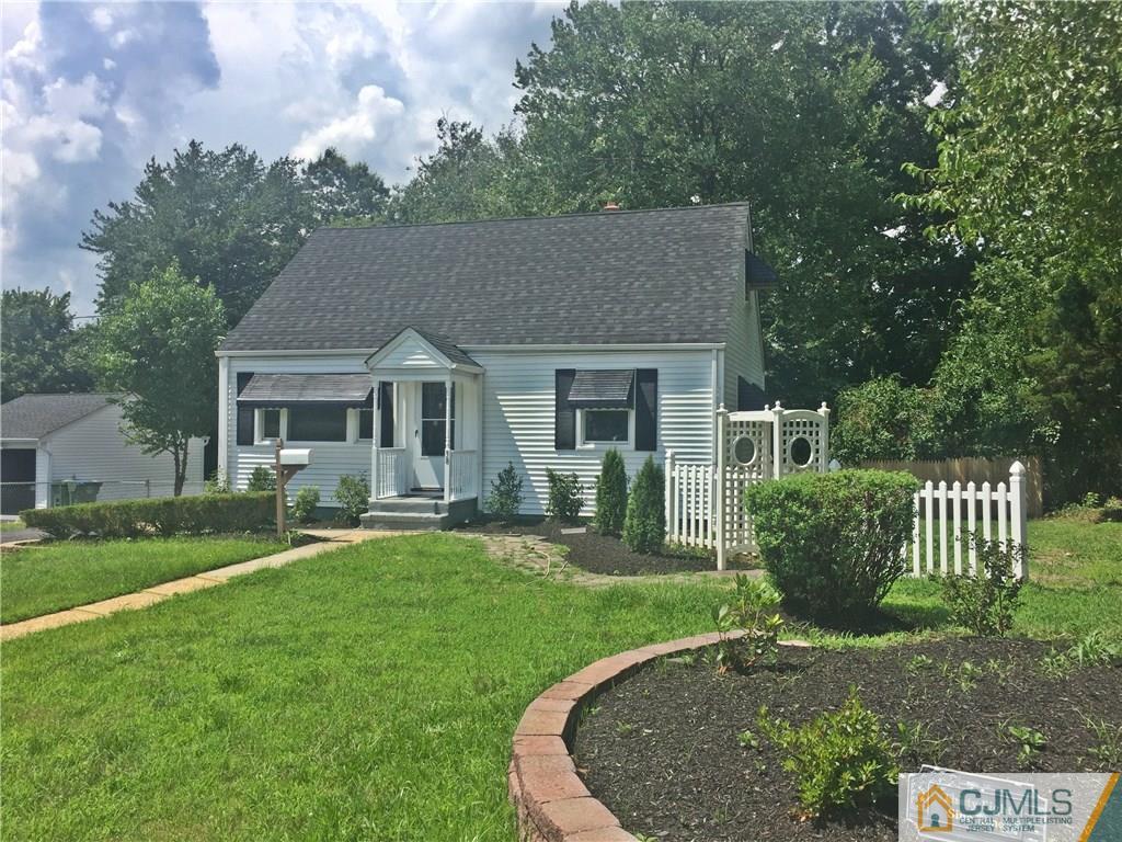 38 Sine Road Edison, NJ 08817 - Photo 3 of 15 a front view of a house with a yard table and chairs
