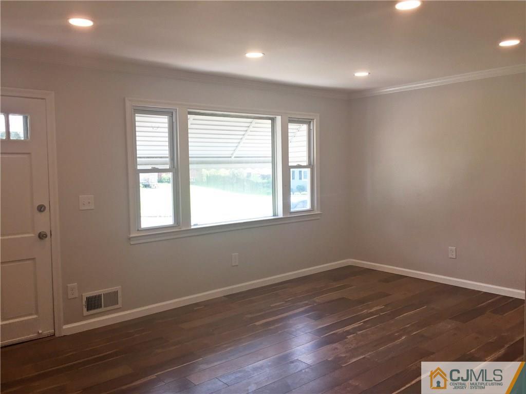 38 Sine Road Edison, NJ 08817 - Photo 4 of 15 wooden floor in an empty room with a window