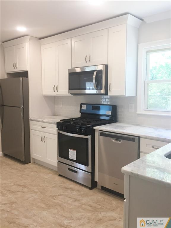 38 Sine Road Edison, NJ 08817 - Photo 5 of 15 a kitchen with a sink stove and microwave
